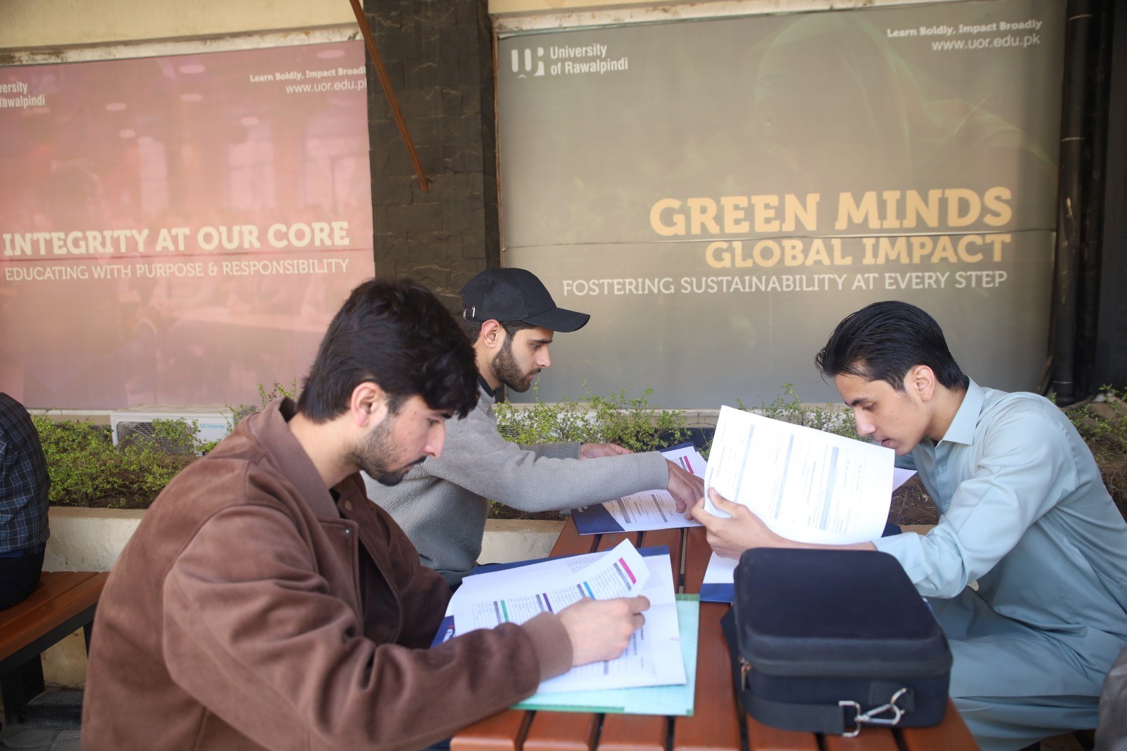 Students reviewing academic information and documents at UOR.